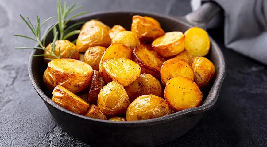 Es ist besser, kleine Kartoffeln in einer Bratpfanne in zwei Schritten zu braten: Zuerst bei starker Hitze anbraten, dann mit einem Deckel abdecken und bei schwacher Hitze fertig garen.  